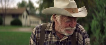 Movie still from “The Straight Story” (1999), directed by David Lynch – An older man wearing a cowboy hat and plaid shirt; Close Up shot, Over the shoulder angle