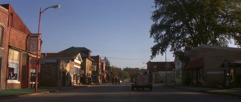 Movie still from “The Straight Story” (1999), directed by David Lynch – A street scene with a truck and a building; Extreme Wide shot, High angle