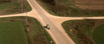 Movie still from “The Straight Story” (1999), directed by David Lynch – An aerial view of a truck driving down a road; Extreme Wide shot, High angle