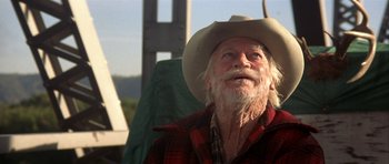 Movie still from “The Straight Story” (1999), directed by David Lynch – An old man wearing a cowboy hat looking up; Close Up shot, Low angle