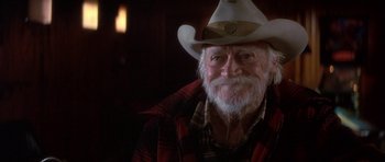 Movie still from “The Straight Story” (1999), directed by David Lynch – An older man wearing a white cowboy hat; Close Up shot, Over the shoulder angle