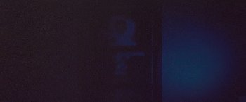 A blurry image of a person in a dark room
