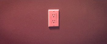 An electrical outlet on the wall in a room