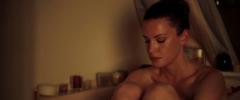 Movie still from “The Strangers” (2008), directed by Bryan Bertino – A woman sitting in a bath tub in a room; Close Up shot, High angle
