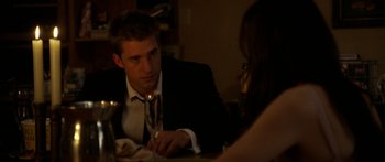 Movie still from “The Strangers” (2008), directed by Bryan Bertino – A man sitting at a table with a woman; Medium shot, Over the shoulder angle