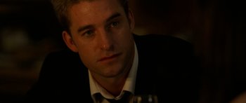 Movie still from “The Strangers” (2008), directed by Bryan Bertino – A person wearing a suit and tie; Close Up shot, Over the shoulder angle