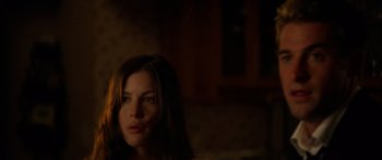 Movie still from “The Strangers” (2008), directed by Bryan Bertino – A woman with long brown hair stares into the camera; Close Up shot, Over the shoulder angle