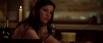 Movie still from “The Strangers” (2008), directed by Bryan Bertino – A woman sitting at a table with a glass of wine in front of her; Close Up shot, Over the shoulder angle