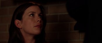 Movie still from “The Strangers” (2008), directed by Bryan Bertino – A person looking at a brick wall; Close Up shot, Over the shoulder angle