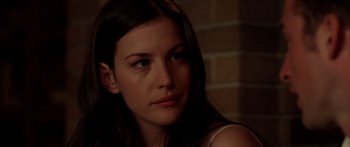 Movie still from “The Strangers” (2008), directed by Bryan Bertino – A person with long brown hair; Close Up shot, Over the shoulder angle