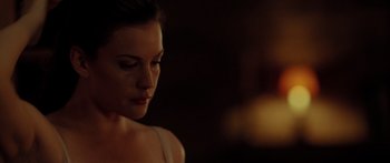 Movie still from “The Strangers” (2008), directed by Bryan Bertino – A beautiful young woman with a candle in the background; Close Up shot, Over the shoulder angle