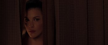 Movie still from “The Strangers” (2008), directed by Bryan Bertino – A person behind a curtain; Close Up shot, Over the shoulder angle