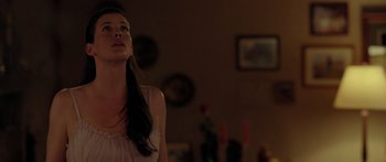 Movie still from “The Strangers” (2008), directed by Bryan Bertino – A woman standing in a living room looking up at the ceiling; Close Up shot, Low angle