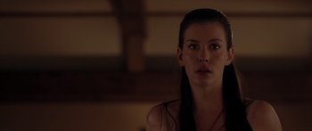 Movie still from “The Strangers” (2008), directed by Bryan Bertino – A beautiful woman with long black hair standing in front of a window; Close Up shot, Over the shoulder angle