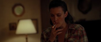 Movie still from “The Strangers” (2008), directed by Bryan Bertino – A woman is smoking a cigarette in the dark; Close Up shot, Over the shoulder angle