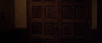 Movie still from “The Strangers” (2008), directed by Bryan Bertino – A wooden door with ornate carvings; Extreme Close Up shot, Overhead angle