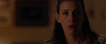 Movie still from “The Strangers” (2008), directed by Bryan Bertino – A person with long dark hair; Close Up shot, Over the shoulder angle