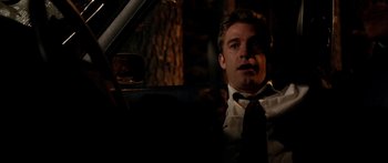 Movie still from “The Strangers” (2008), directed by Bryan Bertino – A man sitting in the driver's seat of a car; Close Up shot, Low angle