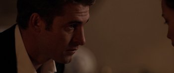 Movie still from “The Strangers” (2008), directed by Bryan Bertino – A man's face in a dark room; Close Up shot, Over the shoulder angle