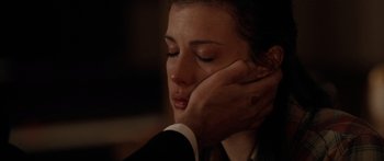 Movie still from “The Strangers” (2008), directed by Bryan Bertino – A person with their hand on their face; Close Up shot, Over the shoulder angle