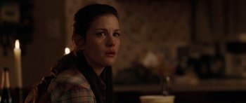 Movie still from “The Strangers” (2008), directed by Bryan Bertino – A person sitting in front of a window; Close Up shot, Over the shoulder angle