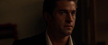 Movie still from “The Strangers” (2008), directed by Bryan Bertino – A person wearing a suit and tie; Close Up shot, Over the shoulder angle