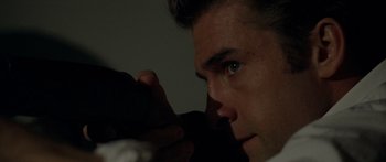 Movie still from “The Strangers” (2008), directed by Bryan Bertino – A man's face in the dark; Extreme Close Up shot, Over the shoulder angle