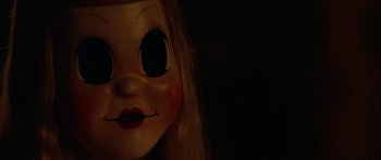 Movie still from “The Strangers” (2008), directed by Bryan Bertino – The face of a creepy doll; Extreme Close Up shot, Over the shoulder angle