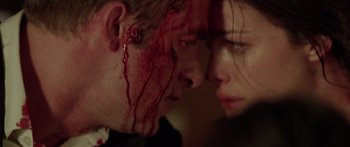 Movie still from “The Strangers” (2008), directed by Bryan Bertino – A man and a woman with blood all over their faces; Extreme Close Up shot, Low angle