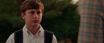 Movie still from “The Strangers” (2008), directed by Bryan Bertino – A young boy wearing a white shirt and a black backpack; Close Up shot, Low angle