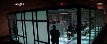 Movie still from “The Sum of All Fears” (2002), directed by Phil Alden Robinson – A group of people sitting at a table in a room; Extreme Wide shot, High angle