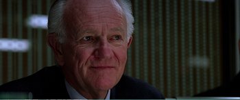 Movie still from “The Sum of All Fears” (2002), directed by Phil Alden Robinson – An older man in a suit and tie; Close Up shot, High angle