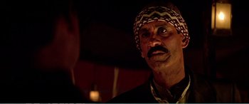 Movie still from “The Sum of All Fears” (2002), directed by Phil Alden Robinson – A person wearing a headscarf; Close Up shot, Over the shoulder angle