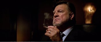 Movie still from “The Sum of All Fears” (2002), directed by Phil Alden Robinson – An older man smoking a cigarette while wearing a ring; Close Up shot, Low angle