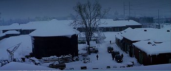 Movie still from “The Sum of All Fears” (2002), directed by Phil Alden Robinson – A person is walking in the snow near a tree; Extreme Wide shot, High angle