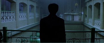 Movie still from “The Sum of All Fears” (2002), directed by Phil Alden Robinson – A man standing on a balcony in the dark; Extreme Wide shot, Over the shoulder angle