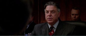 Movie still from “The Sum of All Fears” (2002), directed by Phil Alden Robinson – A person wearing a suit and tie; Close Up shot, Over the shoulder angle