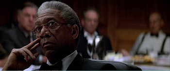 Movie still from “The Sum of All Fears” (2002), directed by Phil Alden Robinson – A person wearing a suit and tie; Close Up shot, Over the shoulder angle