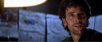 Movie still from “The Sum of All Fears” (2002), directed by Phil Alden Robinson – A man's face with a tent in the background; Close Up shot, Over the shoulder angle