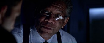 Movie still from “The Sum of All Fears” (2002), directed by Phil Alden Robinson – An older man wearing glasses and wearing a tie; Close Up shot, Low angle