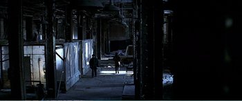 Movie still from “The Sum of All Fears” (2002), directed by Phil Alden Robinson – Two people are walking in an abandoned building; Extreme Wide shot, High angle