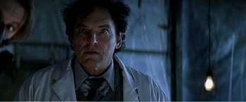 Movie still from “The Sum of All Fears” (2002), directed by Phil Alden Robinson – A person wearing a suit and tie; Close Up shot, Low angle