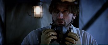 Movie still from “The Sum of All Fears” (2002), directed by Phil Alden Robinson – A man holding a pair of scissors in his hands; Close Up shot, Low angle