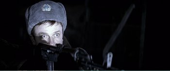 Movie still from “The Sum of All Fears” (2002), directed by Phil Alden Robinson – A man in a hat is looking at the camera; Close Up shot, Low angle