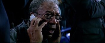 Movie still from “The Sum of All Fears” (2002), directed by Phil Alden Robinson – An older man talking on a cell phone; Close Up shot, High angle