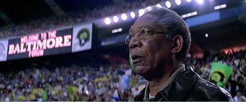 Movie still from “The Sum of All Fears” (2002), directed by Phil Alden Robinson – An older man with glasses in front of an audience; Close Up shot, Low angle