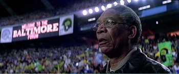 Movie still from “The Sum of All Fears” (2002), directed by Phil Alden Robinson – An older man wearing glasses in front of an audience; Close Up shot, Low angle