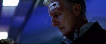 Movie still from “The Sum of All Fears” (2002), directed by Phil Alden Robinson – A man with bandages on his head and forehead; Close Up shot, High angle