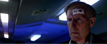 Movie still from “The Sum of All Fears” (2002), directed by Phil Alden Robinson – A person with a bandage on his head; Close Up shot, Low angle