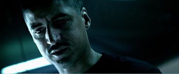 Movie still from “The Sum of All Fears” (2002), directed by Phil Alden Robinson – A man's face in a dark room; Close Up shot, Low angle